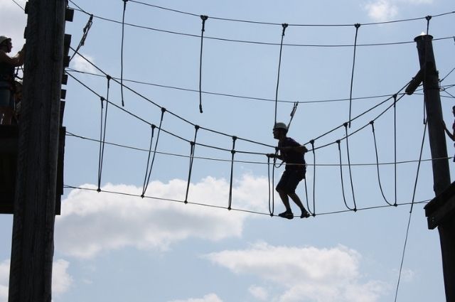 climbing the ropes course at Baytowne Adventure Zone